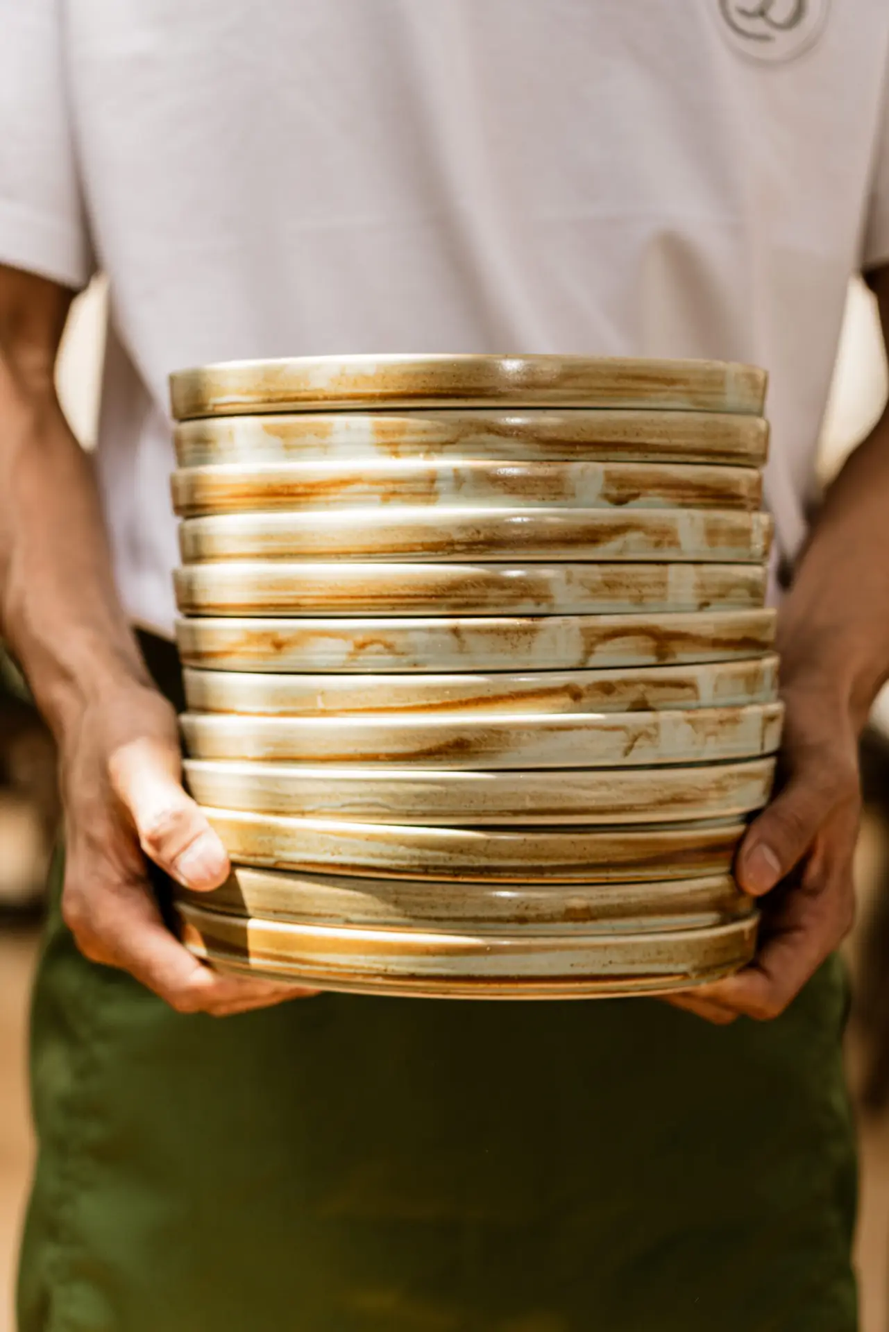 bizou cafe & grill server holding a stack of plates